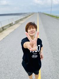 Portrait of smiling man standing on road