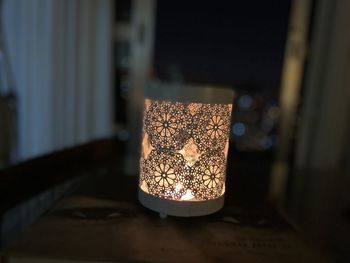 Close-up of illuminated light on table at home