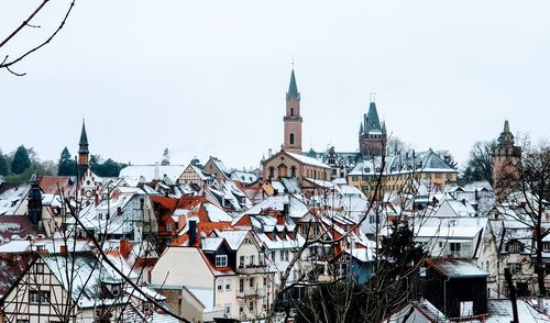 View of buildings in city against clear sky