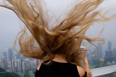 Midsection of woman against sky