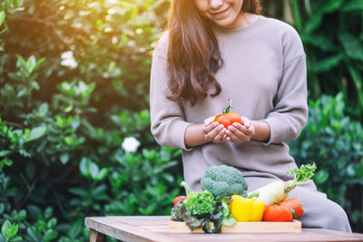 Midsection of woman holding fruits