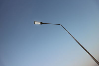 Low angle view of street light against clear blue sky