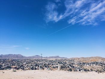 Scenic view of mountains against blue sky