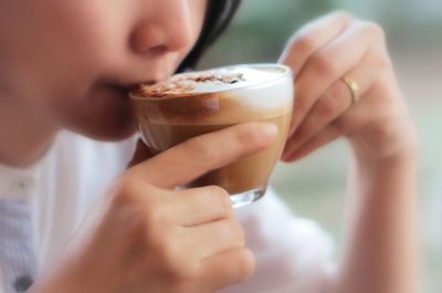 Close-up of woman holding coffee cup