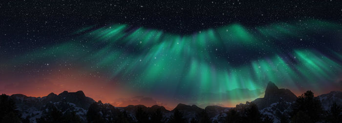 Scenic view of snowcapped mountains against sky at night