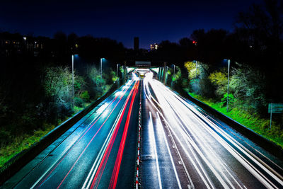 Light trails on road in city at night