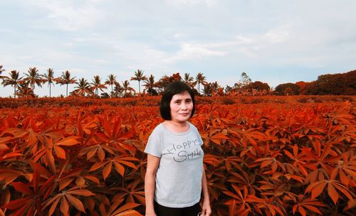 Portrait of smiling girl standing on land against sky