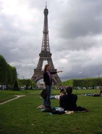 Tourists on hill against cloudy sky