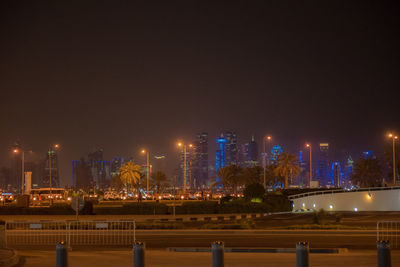 Illuminated buildings against sky at night