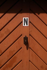 Letter n on brown door