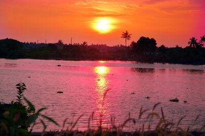 Scenic view of lake against orange sky