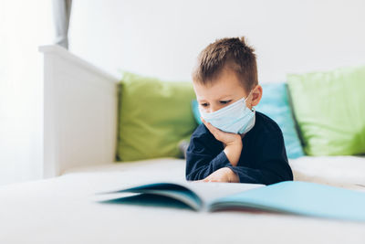 Boy on book at home