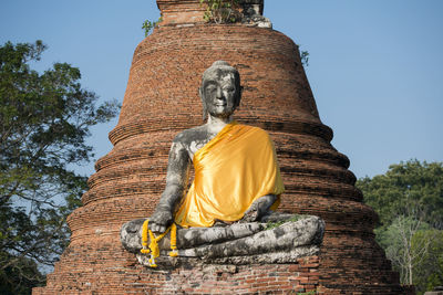 Low angle view of buddha statue at wat mahathat