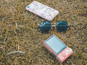 High angle view of sunglasses on field