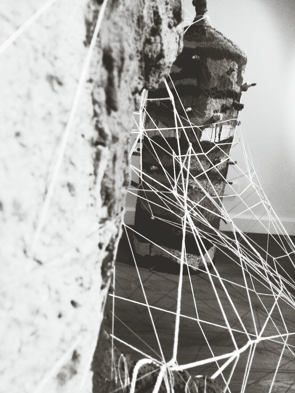 low angle view, built structure, architecture, close-up, metal, outdoors, day, pattern, no people, circle, sky, building exterior, geometric shape, damaged, complexity, electricity, focus on foreground, broken, spider web, sunlight