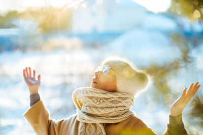 Woman with arms raised during winter