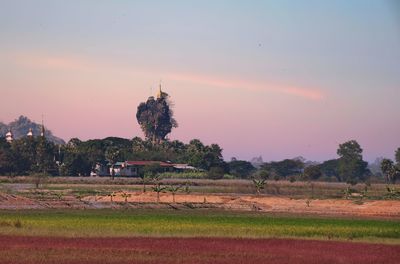 Kyauk ka latt pagoda by landscape against sky during sunset