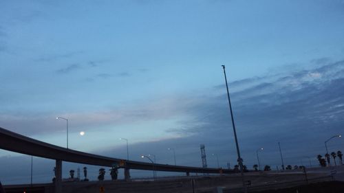 Low angle view of street light against blue sky