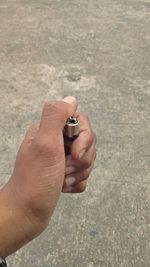 Close-up of hand holding cigarette