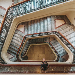 Low angle view of man standing on spiral staircase