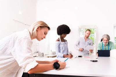 Group of people using laptop on table