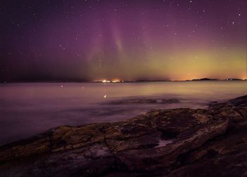 Scenic view of sea against sky at night