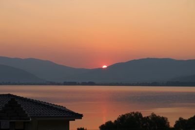 Scenic view of lake against romantic sky at sunset