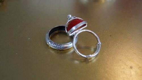 Close-up of wedding rings on table