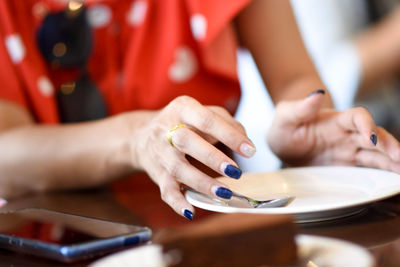 Close-up of woman preparing food on table