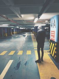 Full length of man on illuminated underground walkway