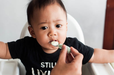 Portrait of cute boy eating baby