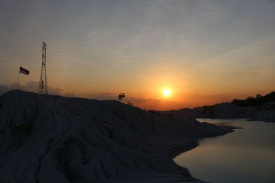 Scenic view of snowcapped mountains against sky during sunset