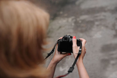 Rear view of man photographing camera