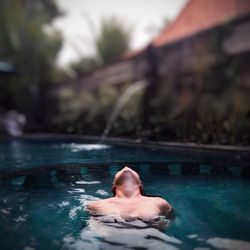 Young woman swimming in pool