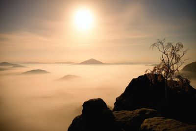 Scenic view of silhouette mountains against sky during full moon