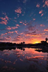 Scenic view of lake against romantic sky at sunset