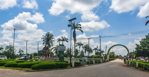 Street by road against sky in city