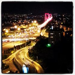 Illuminated city against sky at night