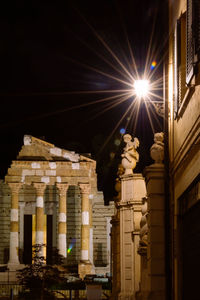 Low angle view of building lit up at night