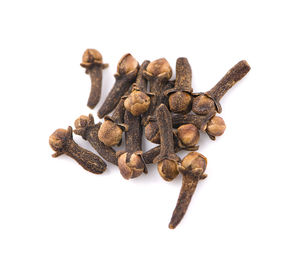 Close-up of broken coffee beans against white background