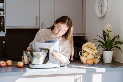 Woman sitting at table at home