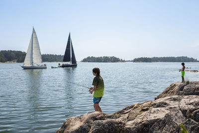 Boy fishing at lake