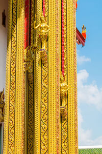 Close-up of yellow temple against sky