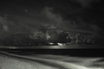 Scenic view of sea against sky at night