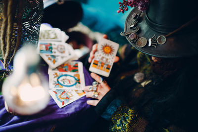 High angle view of gypsy woman holding cards