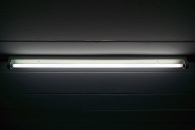 Low angle view of illuminated light on wall