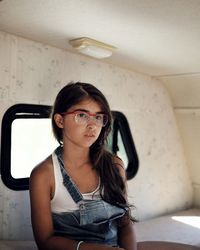 Portrait of young woman sitting at home