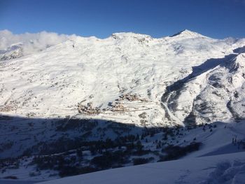 Close-up of ski lift against snowcapped mountain