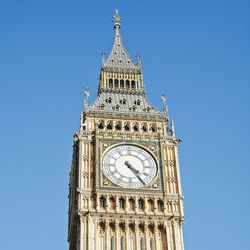 Low angle view of clock tower against clear sky