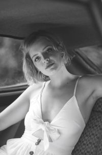 Portrait of a beautiful young woman sitting outdoors